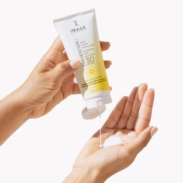 IMAGE PREVENTION+® daily matte moisturizer SPF 30 front view squeezing from tube into hand